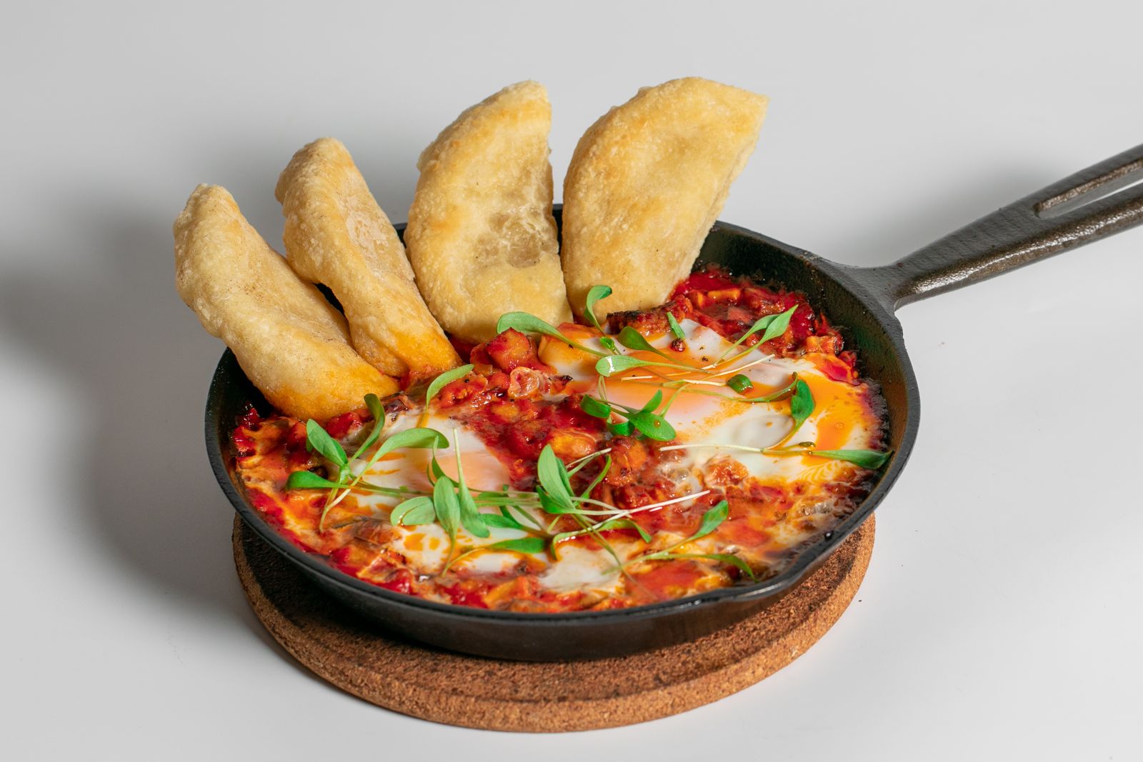 Shakshouka Chorizo in a cast-iron pan with house bread